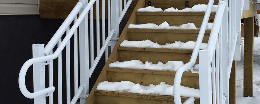 Staircase in winter with pipe railing system