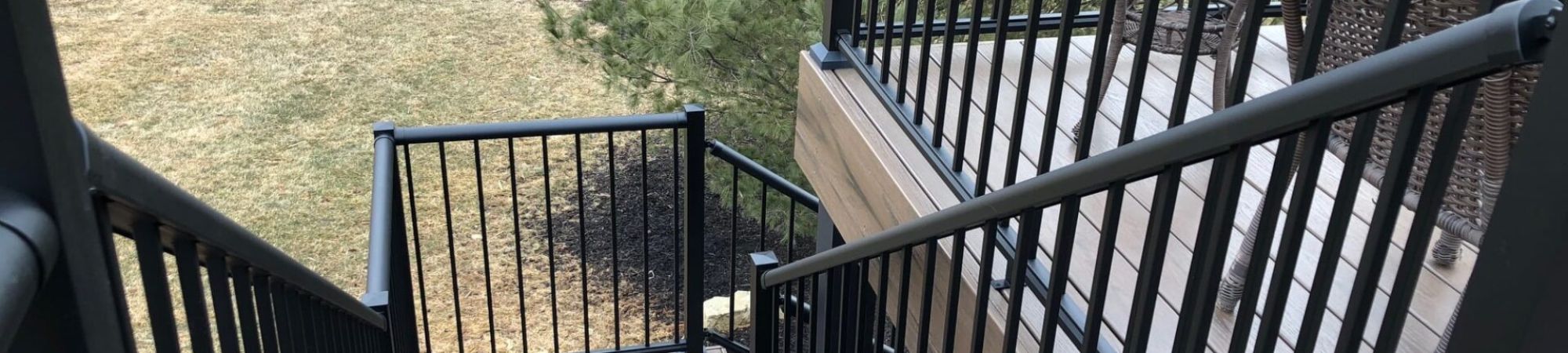 Staircase with black aluminum picket railings