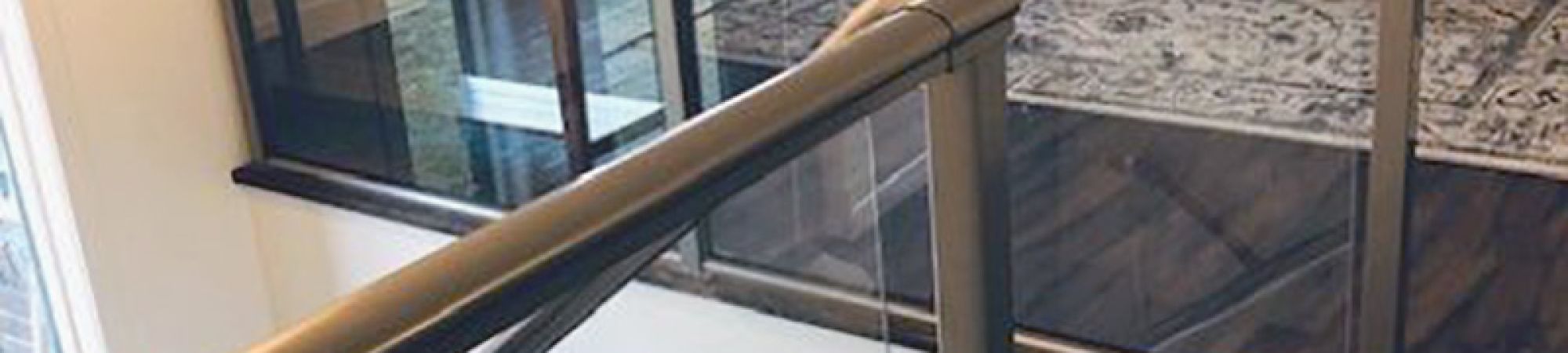Framed glass stair railing in a living room