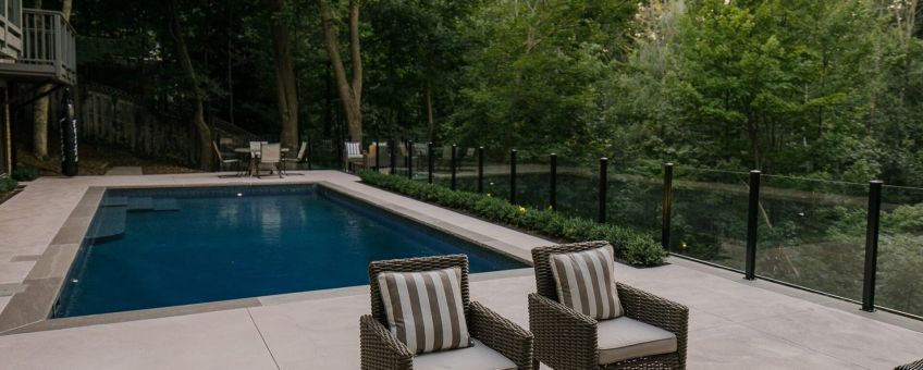 Glass railings in backyard by pool