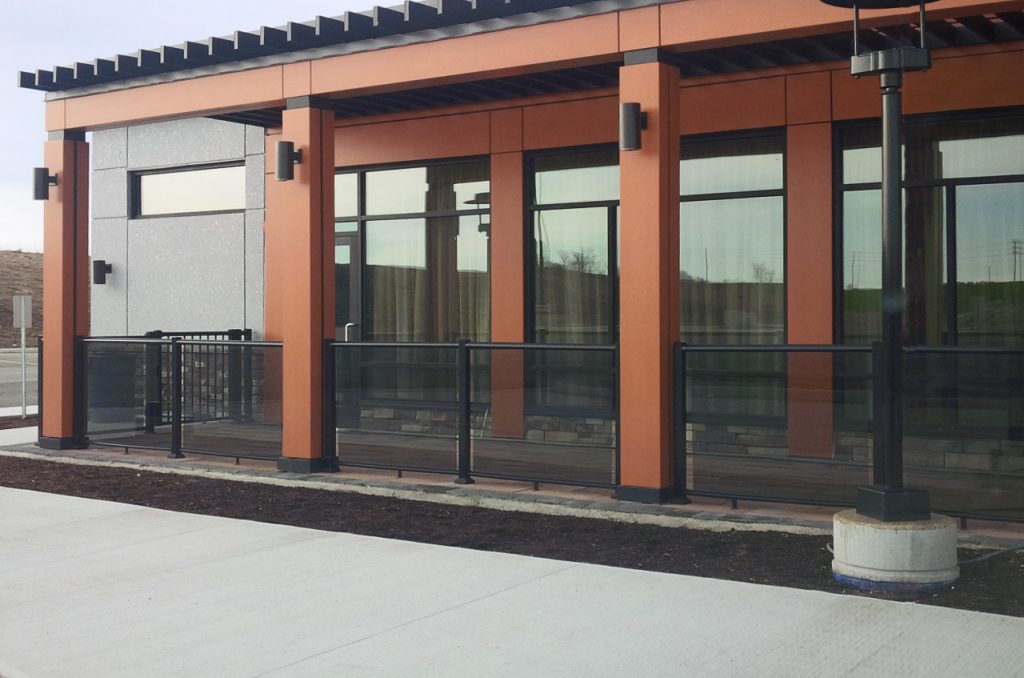 Aluminum and glass railing system connecting to wood posts