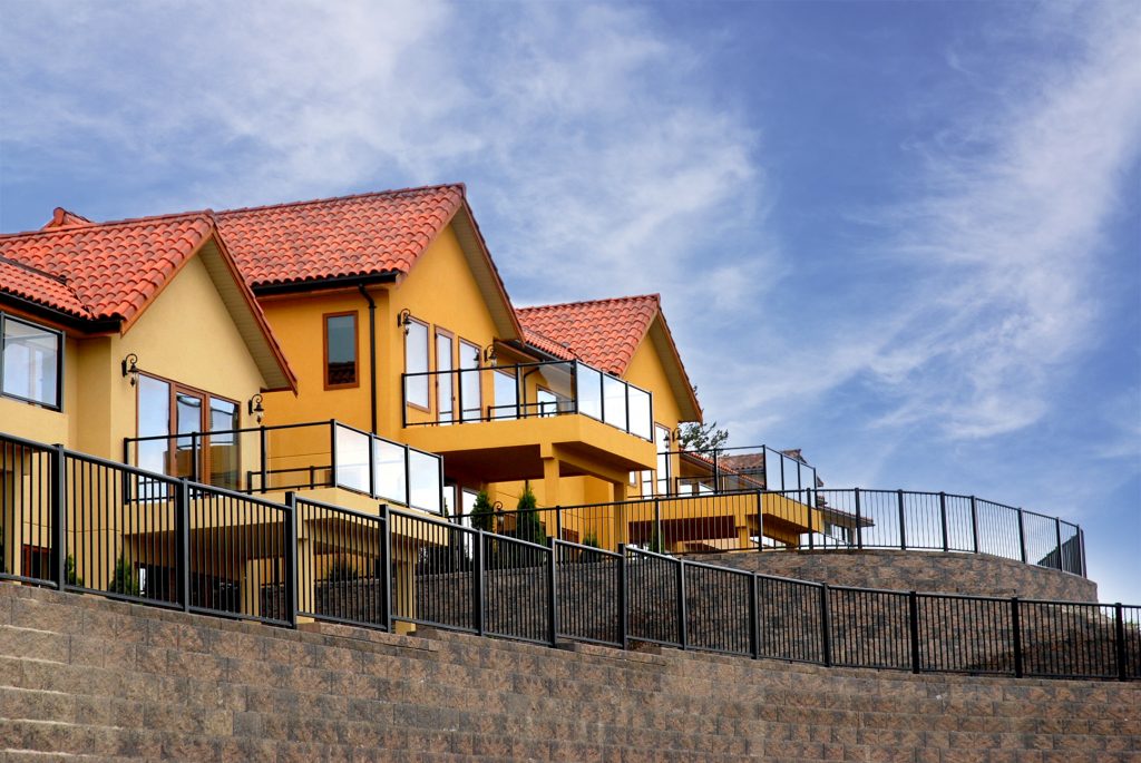House with aluminum picket railings in the back yard