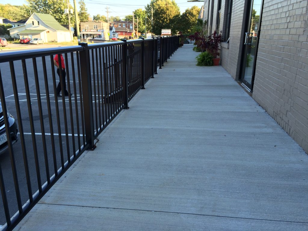 Black picket support railing in a commercial business complex