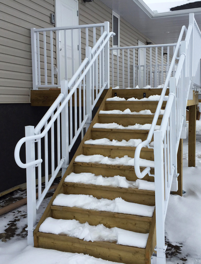 Staircase in winter with pipe railing system