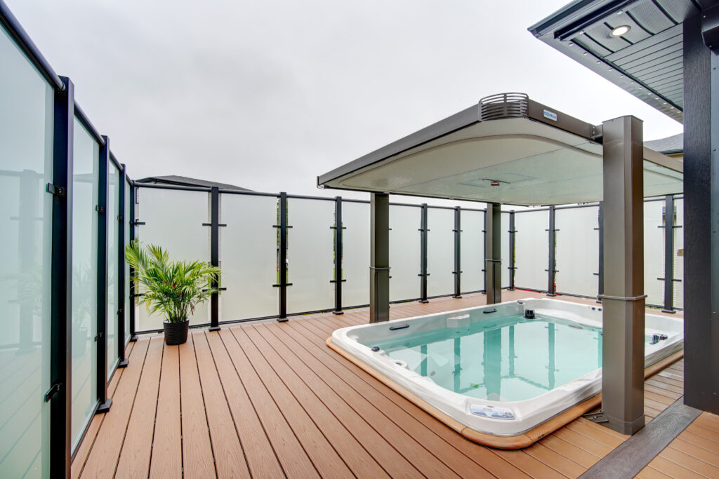 Century Aluminum Acid Etch Glass Privacy Wall surrounding a deck with a hot tub