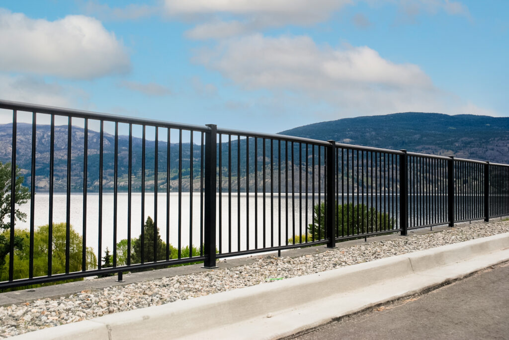 Picket railing at the edge of a driveway