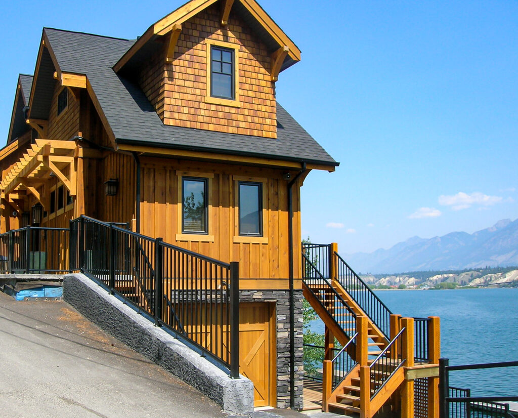 Wood frame home with black picket railing