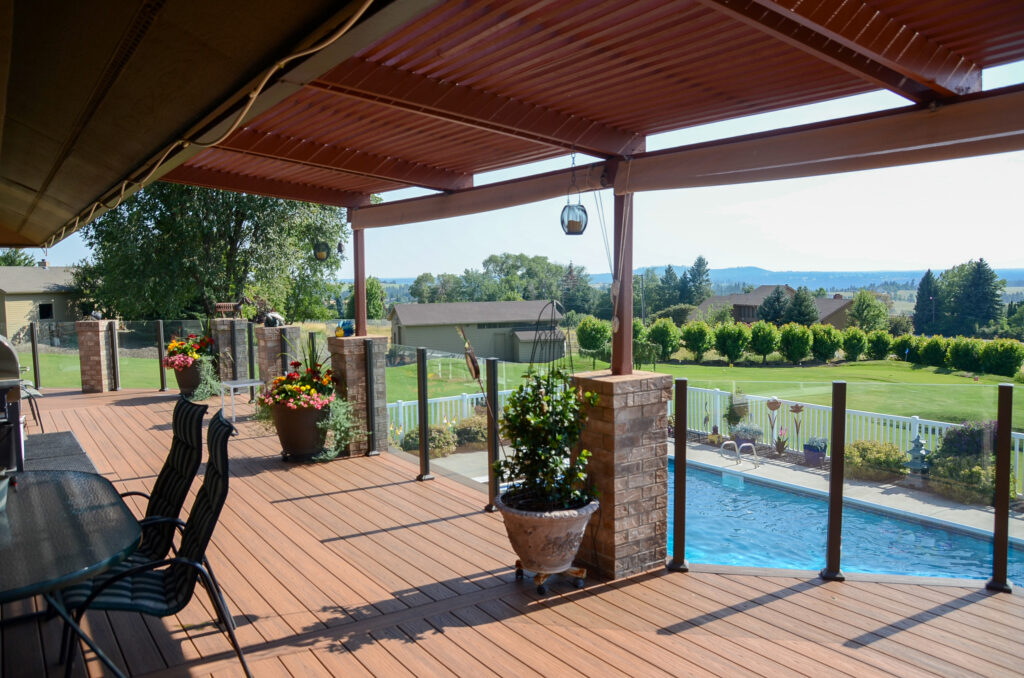 Frameless glass railings on a deck overlooking a swimming pool