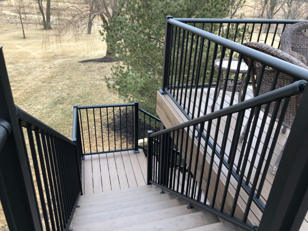 Staircase with black aluminum picket railings