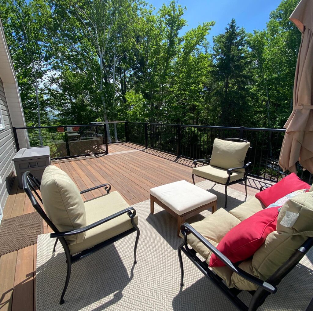 Backyard deck with Textured Black Picket Railing by Century & Dyskstra Contracting