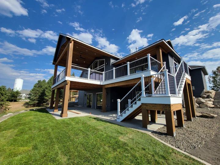 New home with White & Black Picket Railing on the deck and outdoor staircase